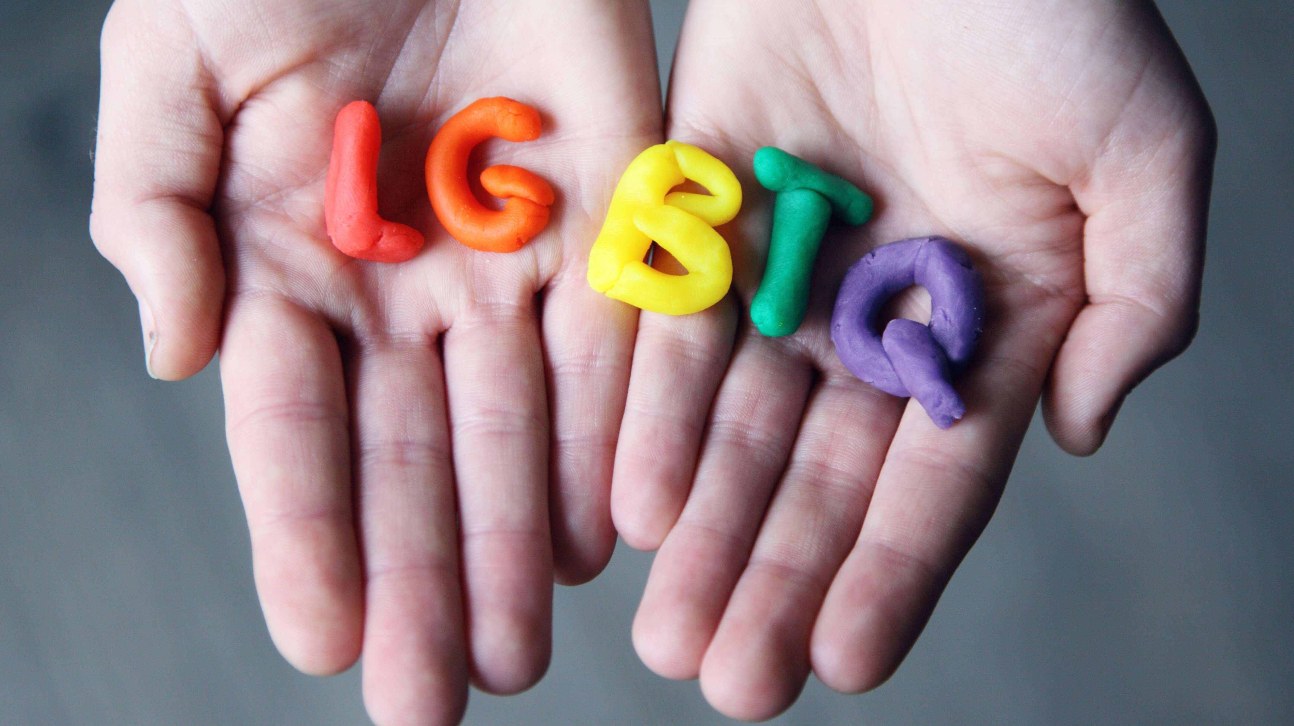 LGBT+ letter figures in a hand